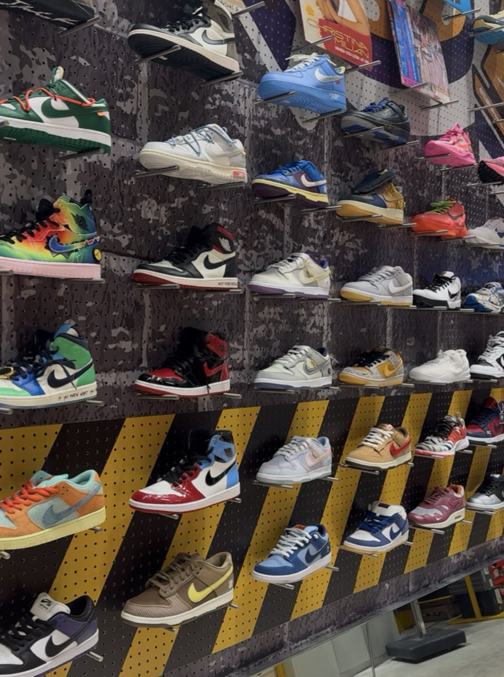 Wall of Nike Dunks, Air Jordans and Air Force 1s on display racks in the Soleverse stockroom